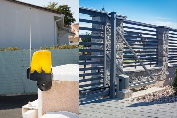 The image shows an electric sliding gate with a metal fence and stone pillars. On the left, there is a yellow warning light on a post, indicating the gate's automation system. The gate is partially open, and the mechanism box is visible near the bottom, suggesting recent work by gate technicians.