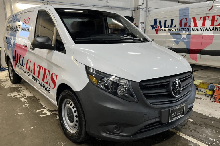 A white van with "All Gates" printed on the side along with "REPAIR, INSTALLATION, MAINTENANCE" services for electric gates and gate openers. The van also displays "24-7 services," showcasing the company's contact details and logo featuring a star and partial flag design in the background.